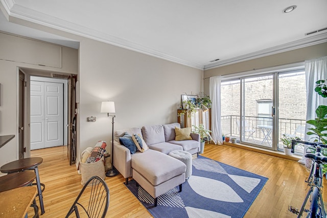 living room with crown molding and hardwood / wood-style flooring