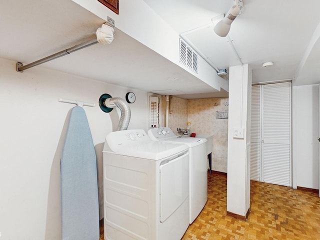 washroom featuring light parquet flooring and washer and dryer