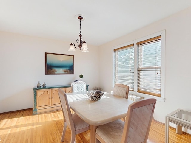 dining room with a chandelier and light wood-type flooring