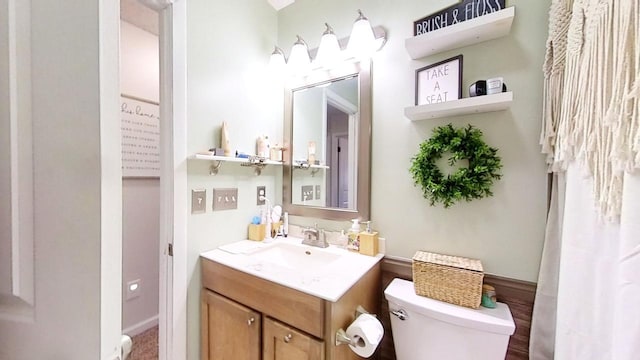 bathroom featuring vanity and toilet