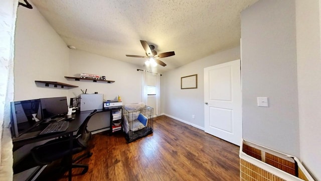 home office featuring dark wood-type flooring, ceiling fan, lofted ceiling, and a textured ceiling