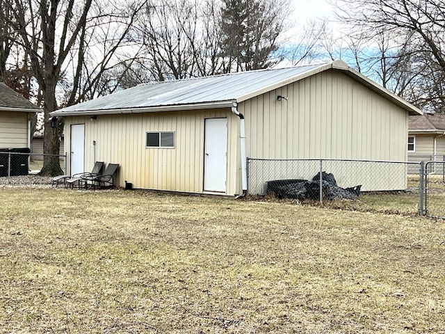 view of outbuilding featuring a yard and central AC unit