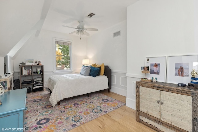 bedroom with vaulted ceiling, ceiling fan, and hardwood / wood-style floors