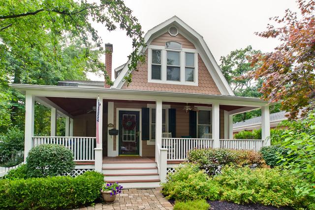 country-style home featuring ceiling fan and covered porch