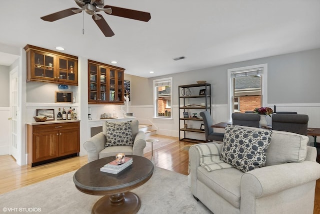 living room with ceiling fan and light hardwood / wood-style floors