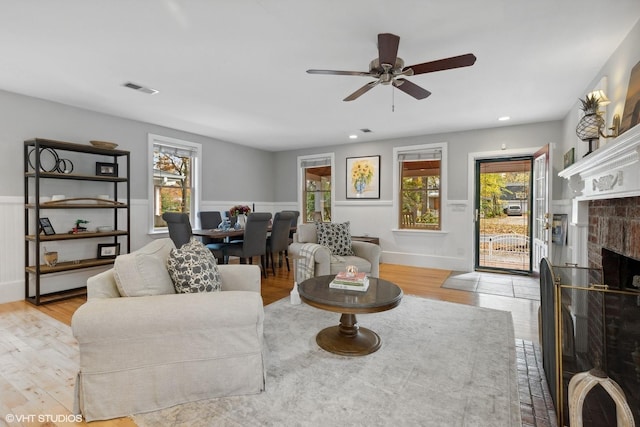 living room featuring ceiling fan and light wood-type flooring