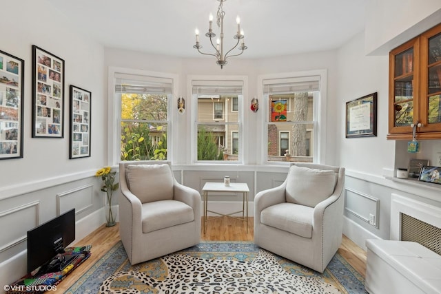 sitting room featuring light hardwood / wood-style floors and a chandelier