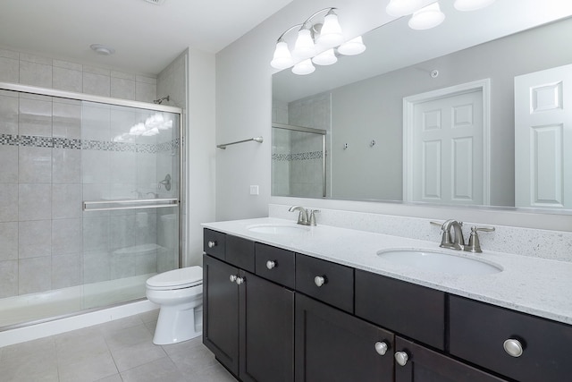 bathroom with an enclosed shower, tile patterned floors, and toilet