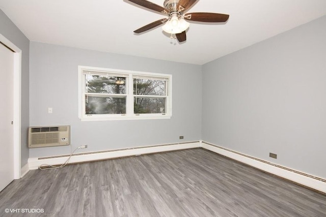 unfurnished bedroom with ceiling fan, an AC wall unit, wood-type flooring, and a baseboard heating unit