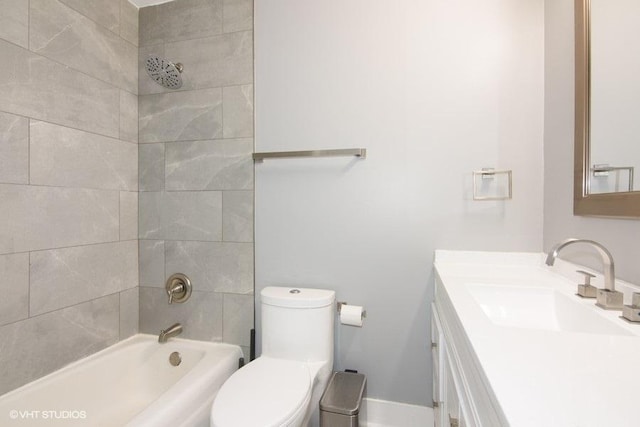 full bathroom featuring vanity, toilet, and tiled shower / bath combo