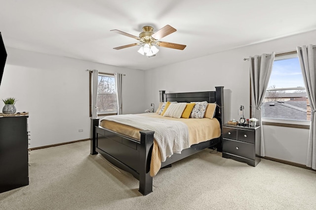 bedroom featuring light colored carpet and ceiling fan