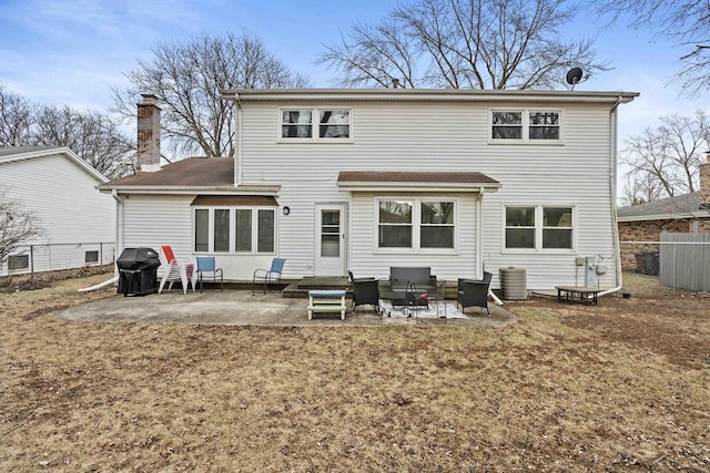 rear view of house featuring cooling unit and a patio area