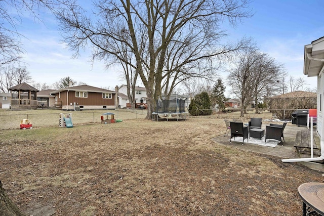 view of yard featuring a patio and a trampoline