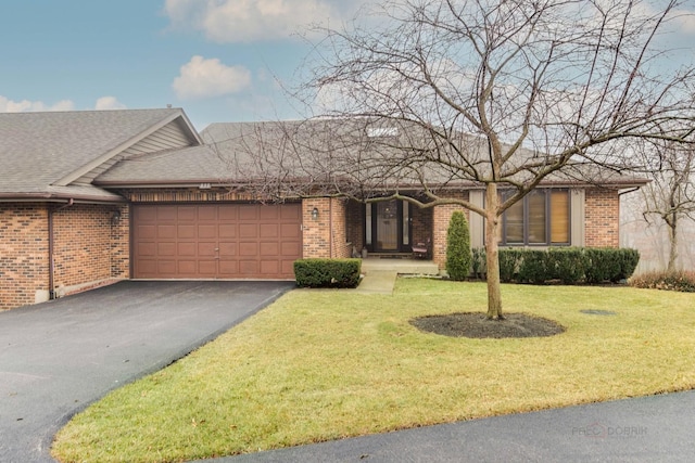 single story home featuring a garage and a front lawn