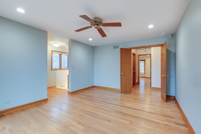 empty room featuring ceiling fan, light hardwood / wood-style floors, and a healthy amount of sunlight