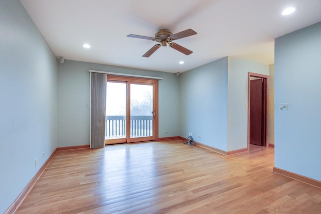 spare room with ceiling fan and light wood-type flooring