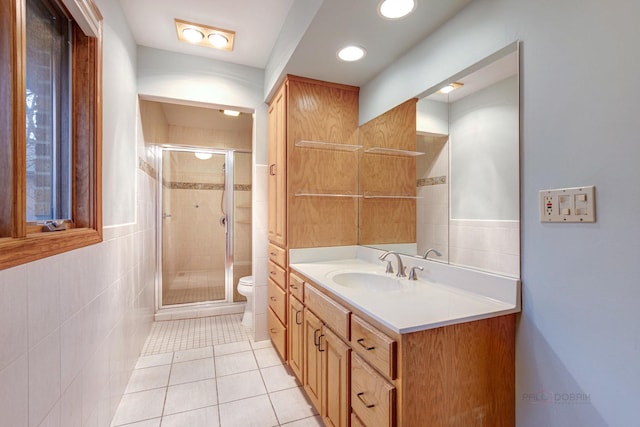 bathroom featuring walk in shower, tile patterned floors, toilet, and vanity