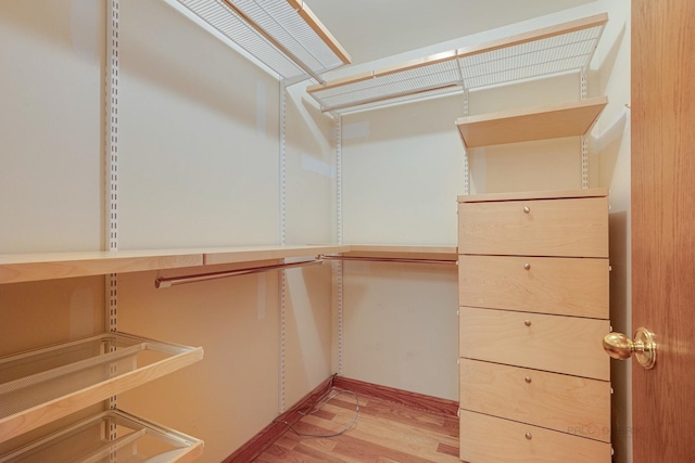 spacious closet with light hardwood / wood-style floors