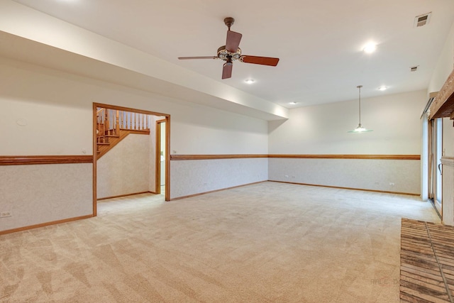 spare room featuring light carpet and ceiling fan