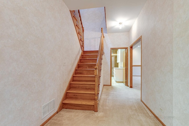 stairs featuring carpet floors