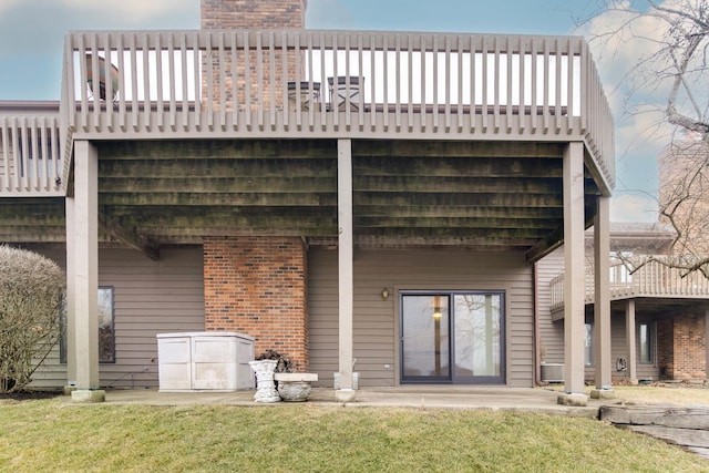 rear view of house featuring a patio area and a lawn