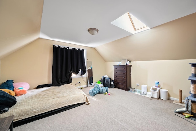 bedroom with lofted ceiling with skylight and carpet flooring