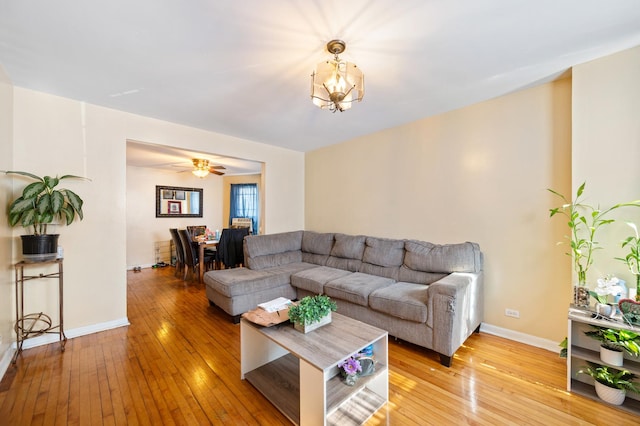 living room with a notable chandelier and light wood-type flooring