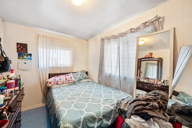 bedroom featuring lofted ceiling and carpet