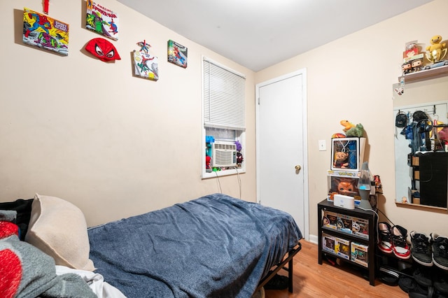 bedroom featuring cooling unit and wood-type flooring