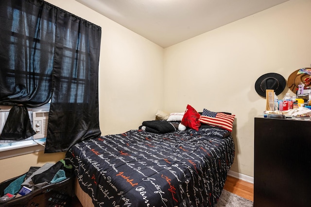 bedroom with lofted ceiling and hardwood / wood-style floors