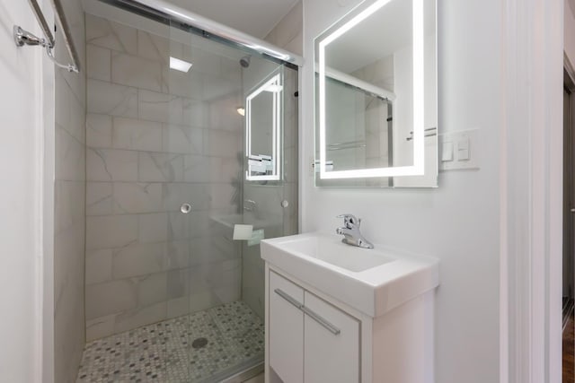 full bath with a stall shower and vanity