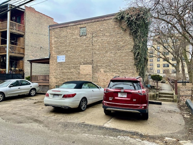 view of building exterior with uncovered parking