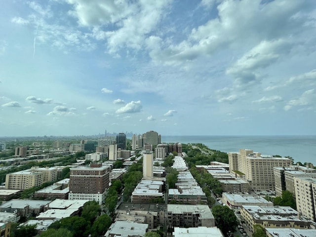 birds eye view of property with a water view and a view of city