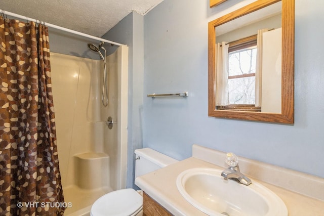 bathroom featuring vanity, toilet, a textured ceiling, and a shower with curtain