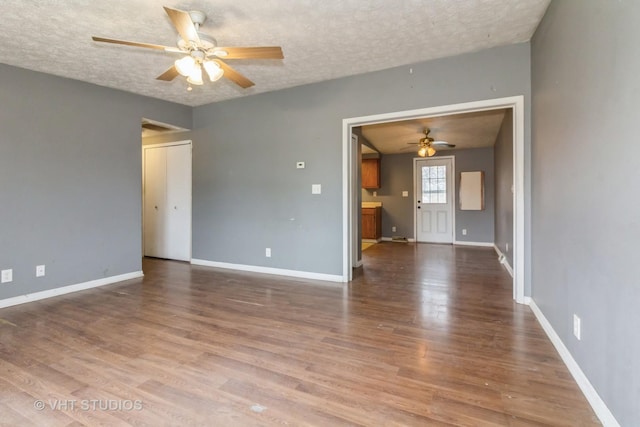 spare room with hardwood / wood-style floors, a textured ceiling, and ceiling fan