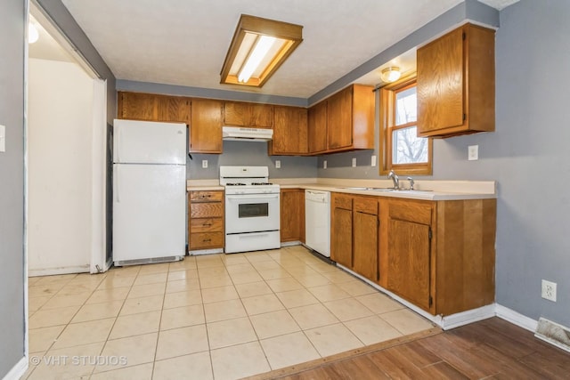 kitchen featuring white appliances and sink