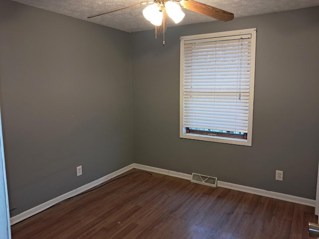 spare room with ceiling fan, wood-type flooring, and a textured ceiling