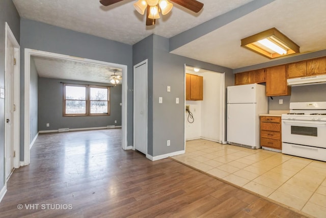 kitchen featuring ceiling fan, a textured ceiling, white appliances, and light hardwood / wood-style flooring