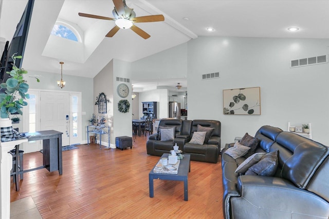 living room with beam ceiling, wood-type flooring, high vaulted ceiling, and ceiling fan