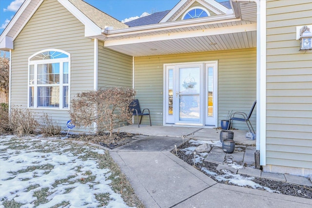 view of snow covered property entrance