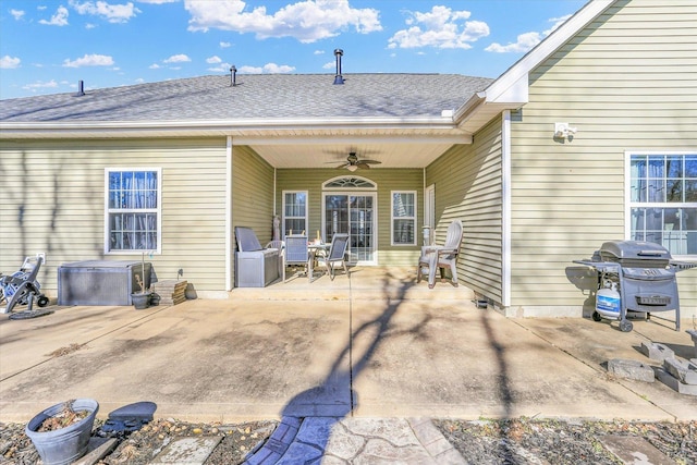 rear view of house with ceiling fan and a patio