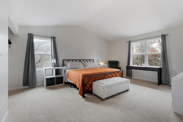 bedroom featuring multiple windows, vaulted ceiling, and carpet floors