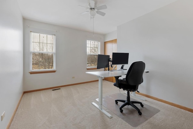 carpeted office featuring ceiling fan