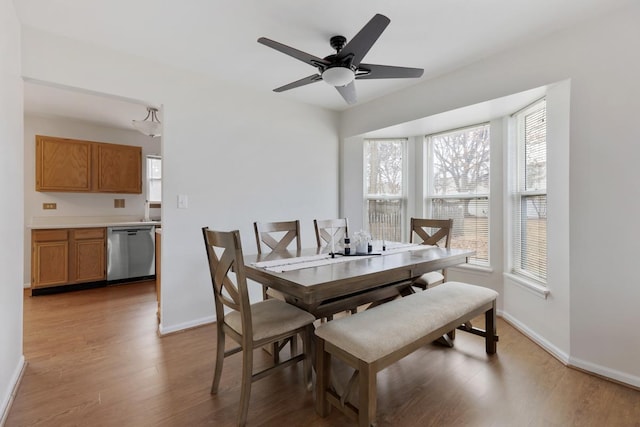 dining room with hardwood / wood-style floors and ceiling fan