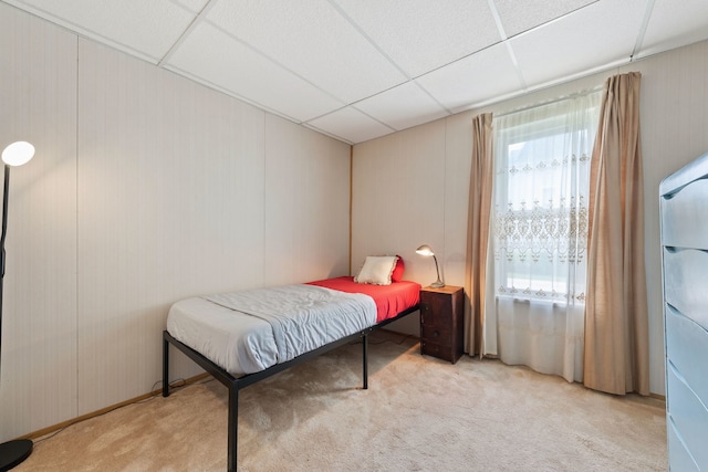 carpeted bedroom with a drop ceiling