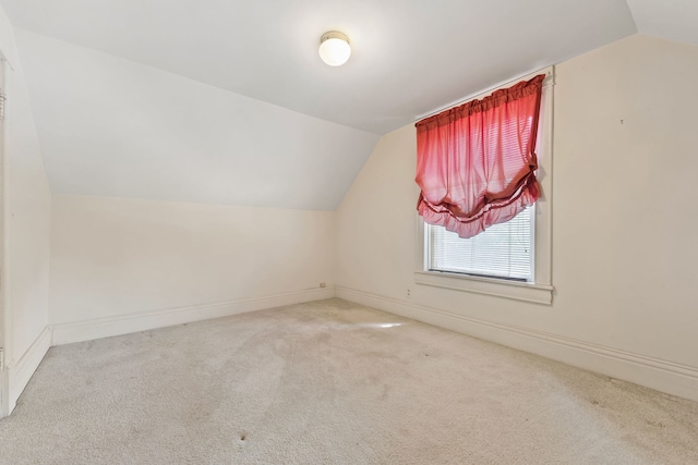 bonus room featuring light carpet and vaulted ceiling