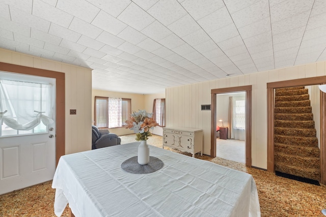 dining space featuring light carpet