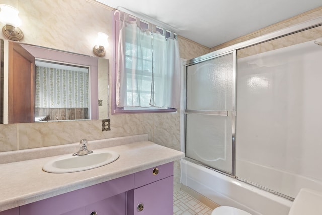 full bathroom with vanity, combined bath / shower with glass door, and toilet