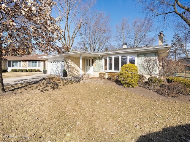 ranch-style house with a garage and a front lawn