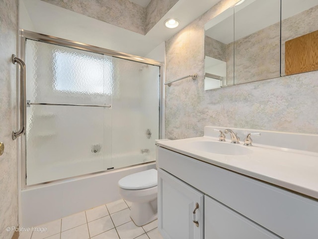 full bathroom with toilet, shower / bath combination with glass door, tile walls, vanity, and tile patterned flooring